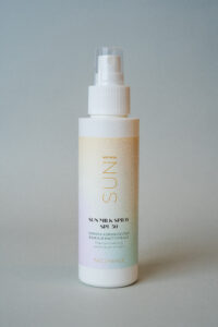 aurinkosuoja in a white bottle with a white label